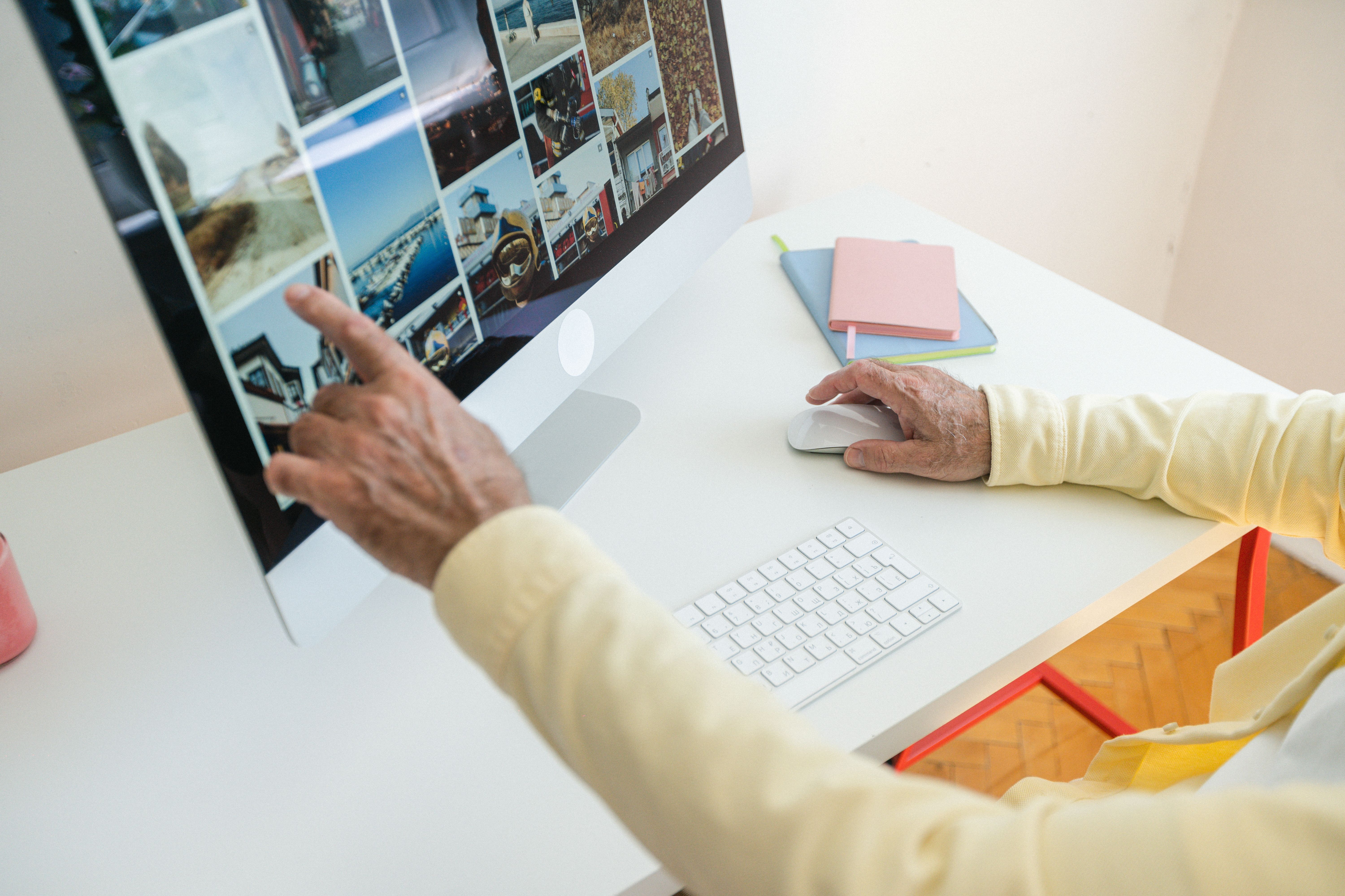 Older adult comparing photos on a desktop computer during a quiet online check